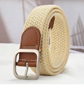 Detail view of a stylish braided elastic belt with brown leather trim and metal square buckle.