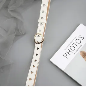 White leather belt with heart cutouts and gold buckle. Stylish casual jeans belt for women.