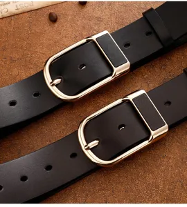 Detailed shot of classic black leather belts with stylish gold pin buckles for men.