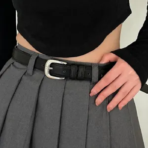 Detailed close-up view of a sleek black leather belt with a polished silver pin buckle.