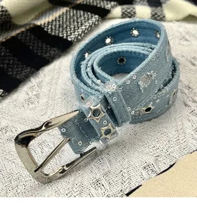 Light blue denim belt detail, featuring silver pin buckle and star metal studs for women.