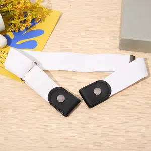 Detail view of a white elastic buckle-free invisible belt with black leather snap buttons.