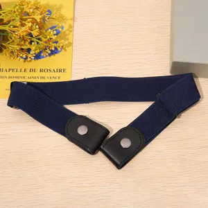 Detail view of navy blue invisible elastic waist belt with leather ends and metal snap buttons.