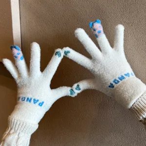 Detail shot of cute white knitted winter gloves with Panda text, warm and touch screen compatible.