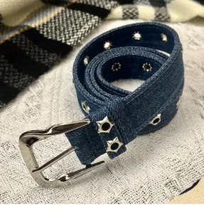 Denim belt with star grommets and metal pin buckle, versatile accessory for casual jeans styling.