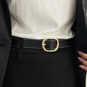 Women stylish black leather belt with gold oval buckle, versatile waist accessory for jeans.