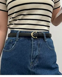 Minimalist black narrow belt for women with elegant gold buckle, perfect for stylish jeans.
