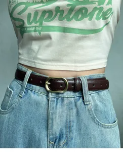 Women's slim brown leather belt with vintage metal pin buckle, perfect jeans accessory.