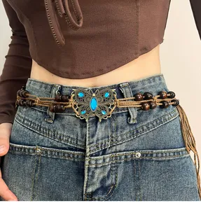Detail shot of bohemian waist chain with metal butterfly and wooden beads for women.