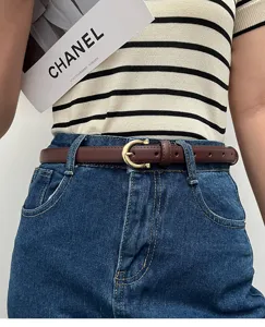 Slim brown leather belt for women, elegant gold buckle, perfect accessory for classic jeans.