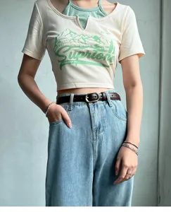 Detailed shot of casual crop top paired with high-waist jeans and leather belt showcasing fashion fit.