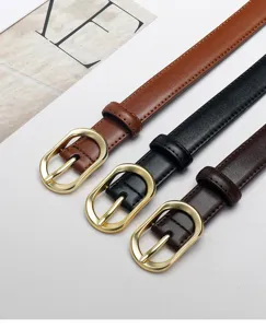 Detailed view of women thin leather belts with gold oval buckles in multiple colors.