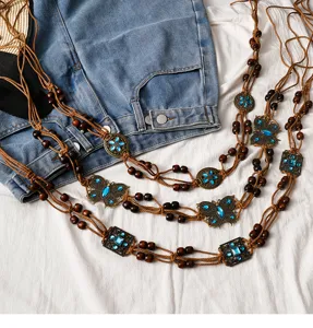 Bohemian vintage waist chain detail, brown beaded woven rope with blue gem butterfly
