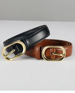 Detail view of stylish women's black and brown leather belts with elegant golden oval buckles.
