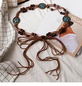 Bohemian vintage braided waist chain with wooden beads and blue flower metal decor for women.