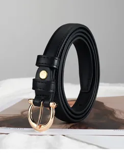 Detailed view of a slim black leather belt featuring a sleek gold horseshoe buckle.