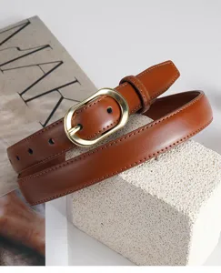Brown leather belt detail, golden oval metal buckle, elegant stitching texture for styling.