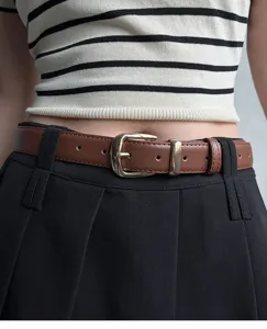 Detailed shot of a stylish brown leather belt with metal pin buckle, perfect for everyday wear.