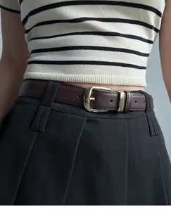 Women vintage brown leather belt with gold metal pin buckle minimal style detail shot