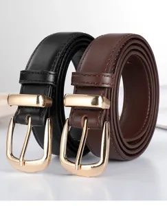 Close-up detail of classic black and brown leather belts featuring elegant gold pin buckles.