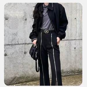 Detail view of the retro black belt featuring a stylish metal buckle and street outfit.