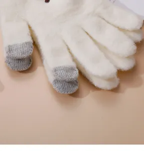 Detail shot of women winter warm knit touchscreen gloves, fleece lined fluffy white style.
