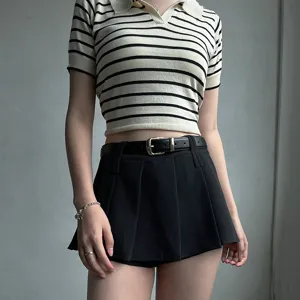 Women's casual striped polo top with a stylish black pin buckle belt and pleated skirt.