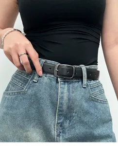 Minimalist black leather belt detail shot, simple metal buckle for women daily wear.