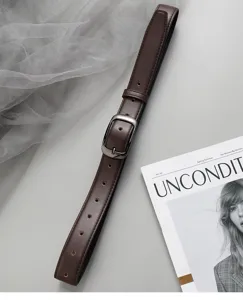 Dark brown women belt close-up, minimalist metal buckle, premium casual jeans accessory detail.