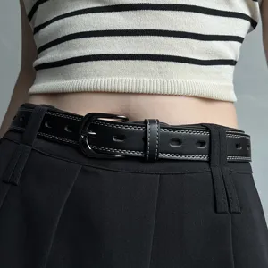 Stylish black leather belt for women with contrast stitching and cutouts, perfect for jeans.