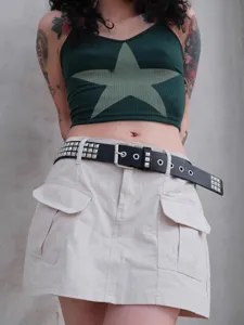 Punk style black leather rivet belt with metal pyramid studs and eyelets detail view.