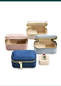 Detailed close-up view of portable velvet jewelry boxes in various colors with ring slots.