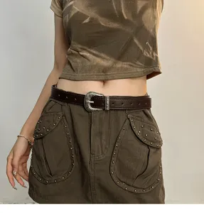 Vintage brown leather belt with retro carved metal buckle for women fashion outfit.