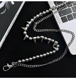 Detailed view of punk style double-layered metal pant chain with spike and bead charms.