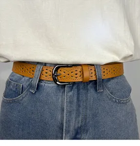 Women's brown hollow out leather belt fashionable waist accessory for casual jeans trousers.