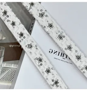 Detail shot of white denim sequin star belt with metal eyelets, trendy Y2K style accessory.
