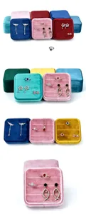 Velvet jewelry box detail showing soft plush texture, compact square shape and multiple slots.