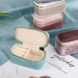 Velvet travel jewelry box mini portable ring organizer case with secure zipper closure.
