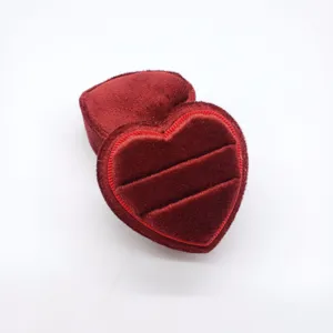 Red heart-shaped velvet ring box for jewelry display, soft interior slots for proposal and wedding.