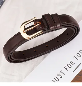 Detailed view of women brown leather belt with gold buckle and clean stitching, elegant style.