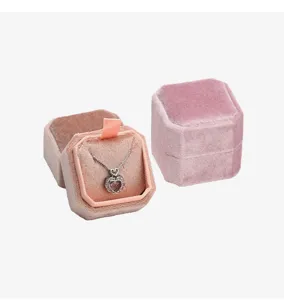Detailed view of luxury pink velvet octagonal necklace jewelry box with heart pendant.