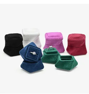 Detail view of multi-color velvet ring boxes, portable jewelry gift storage cases for rings.