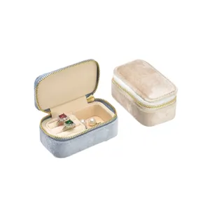 Portable velvet jewelry storage box for rings and earrings, compact travel organizer case.