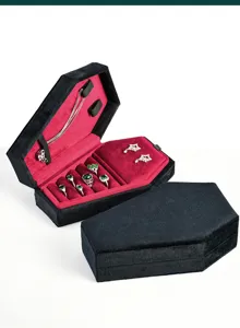 Gothic velvet coffin jewelry box with red interior, ring slots and necklace hooks detail.