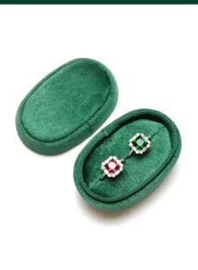 Gedetailleerde close-up van de elegante groene fluwelen ovale ringdoos binnenkant met dubbele sleuf.