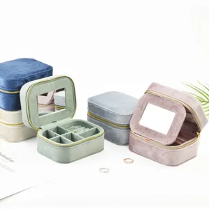 Portable velvet travel jewelry box organizer with mirror and ring slots for women.