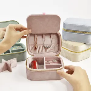 Portable velvet travel jewelry box organizer with multi-compartments for rings and necklaces.