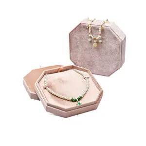 Luxurious velvet jewelry box with pearl necklace set, elegant pink octagonal storage case.