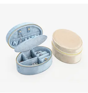 Close-up detail of portable velvet jewelry box with soft ring rolls, compartments and zipper.