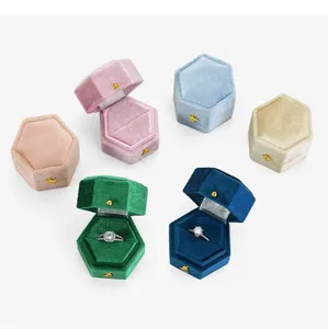 Detailed view of luxury hexagonal velvet ring boxes in multiple colors, perfect for proposals.